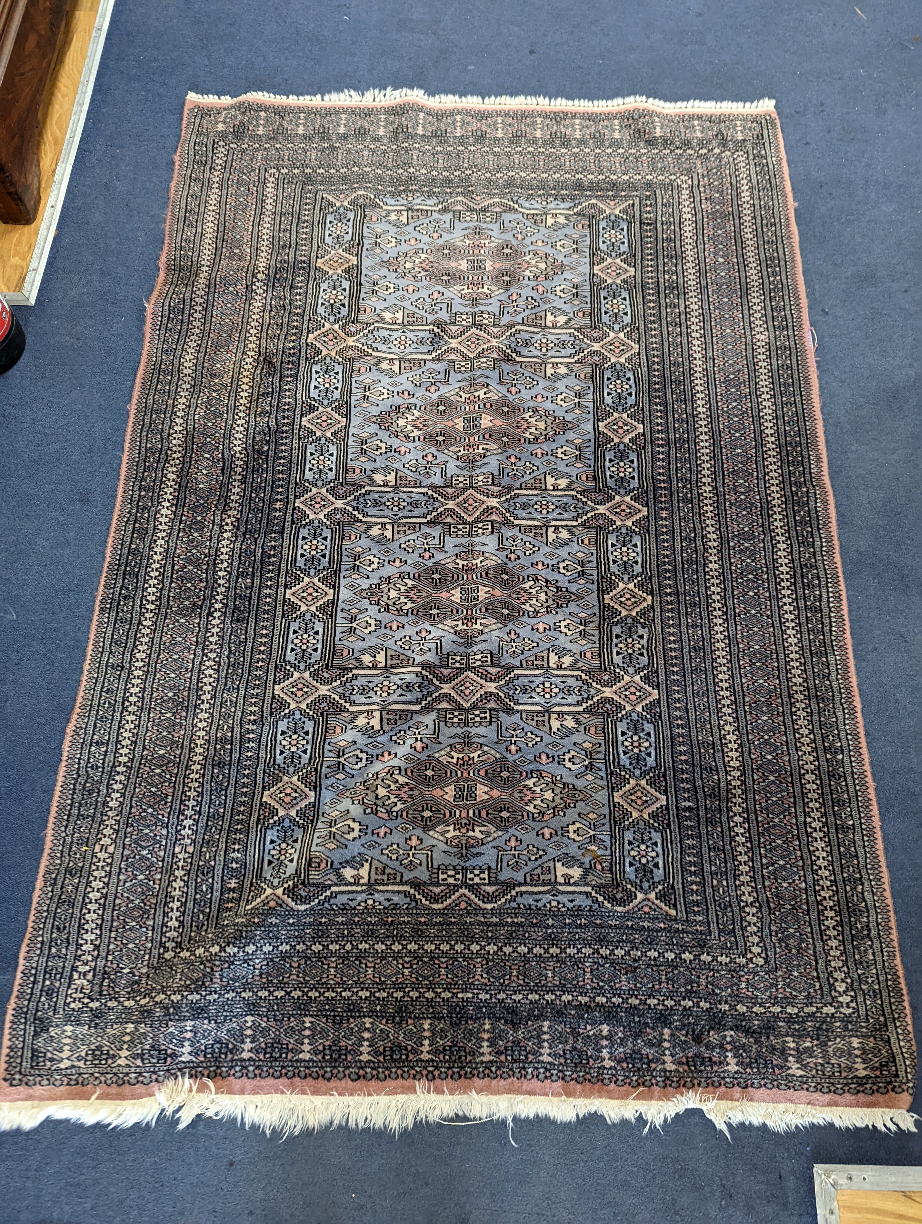 A Bokhara blue ground rug, 190 x 30cm